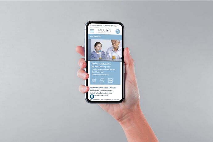 Hand hält ein smartphone auf dem eine Webseite geöffnet ist